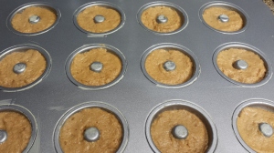 Pumpkin spiced doughnuts smoothed down and ready to go into the oven.